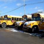 Buses are lined up in the parking lot at Mon Schools transportation department in that from a winter gone by. The current cold idled those buses Thursday as the district pivoted to remote learning. (The Dominion Post file photo).